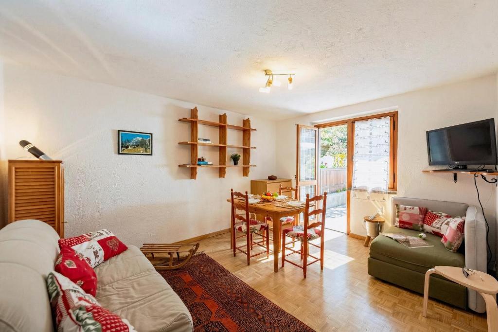 a living room with a couch and a table at Montagne E Coccole - Happy Rentals in Pré-Saint-Didier