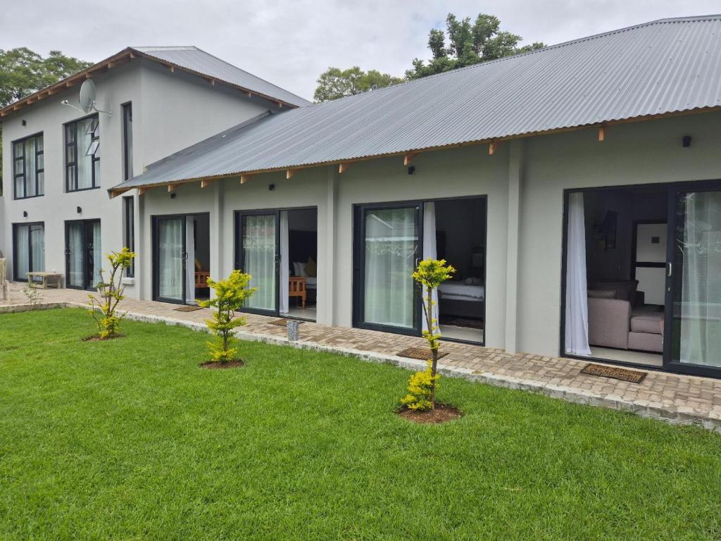 a house with three trees in the yard at Comfort Cove in Pretoria