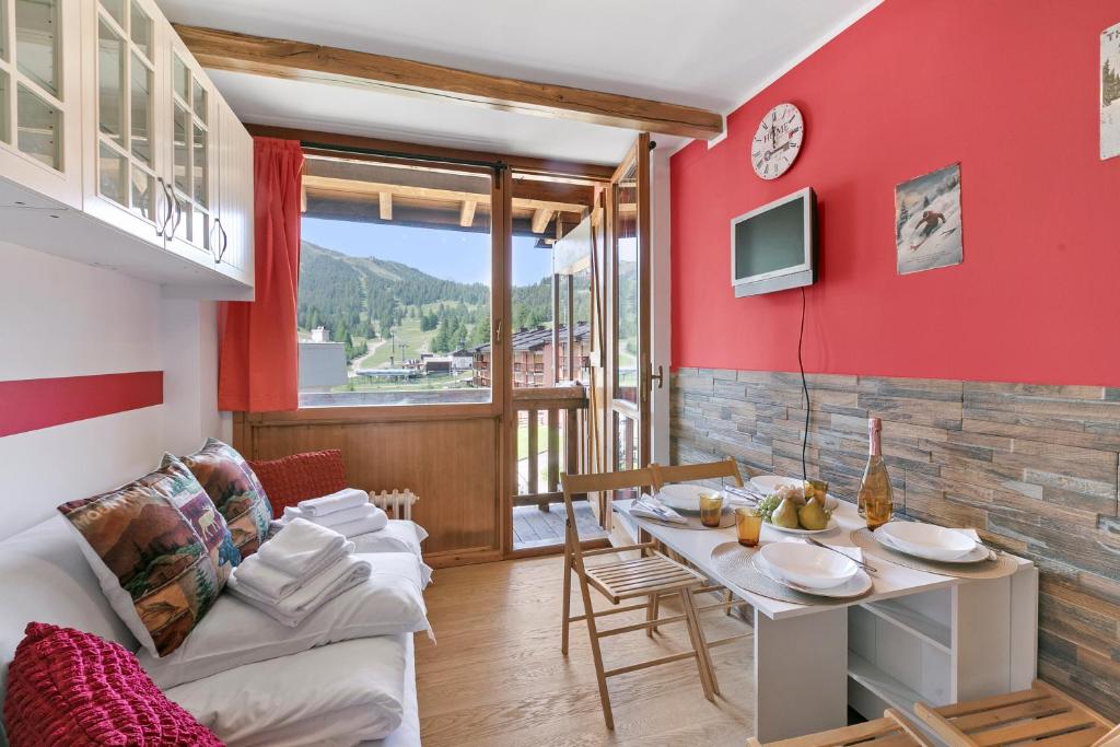a living room with a couch and a table at Studio Valleverde 26B - Happy Rentals in Sestriere