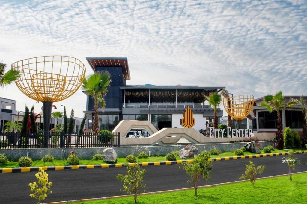 a building with two large metal spheres in front of it at City Center Suites in Bhatinda