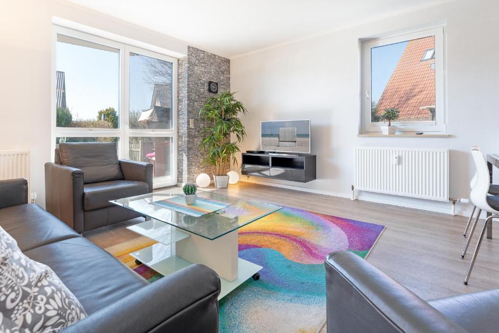 a living room with a couch and a coffee table at Strandlächeln in Neue Tiefe Fehmarn
