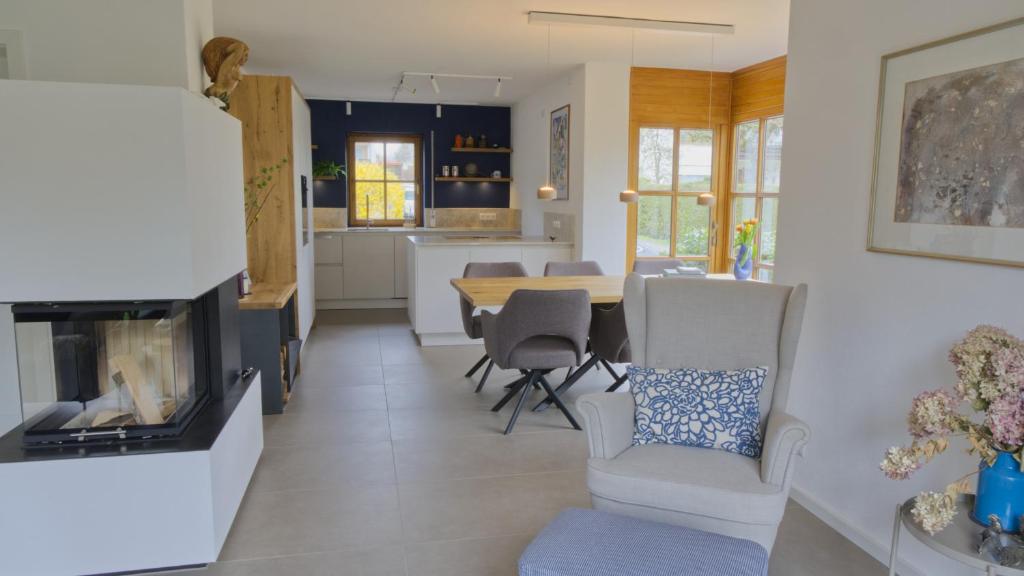 a kitchen and living room with a table and chairs at Ferienhaus Mind-Storm in Rimsting