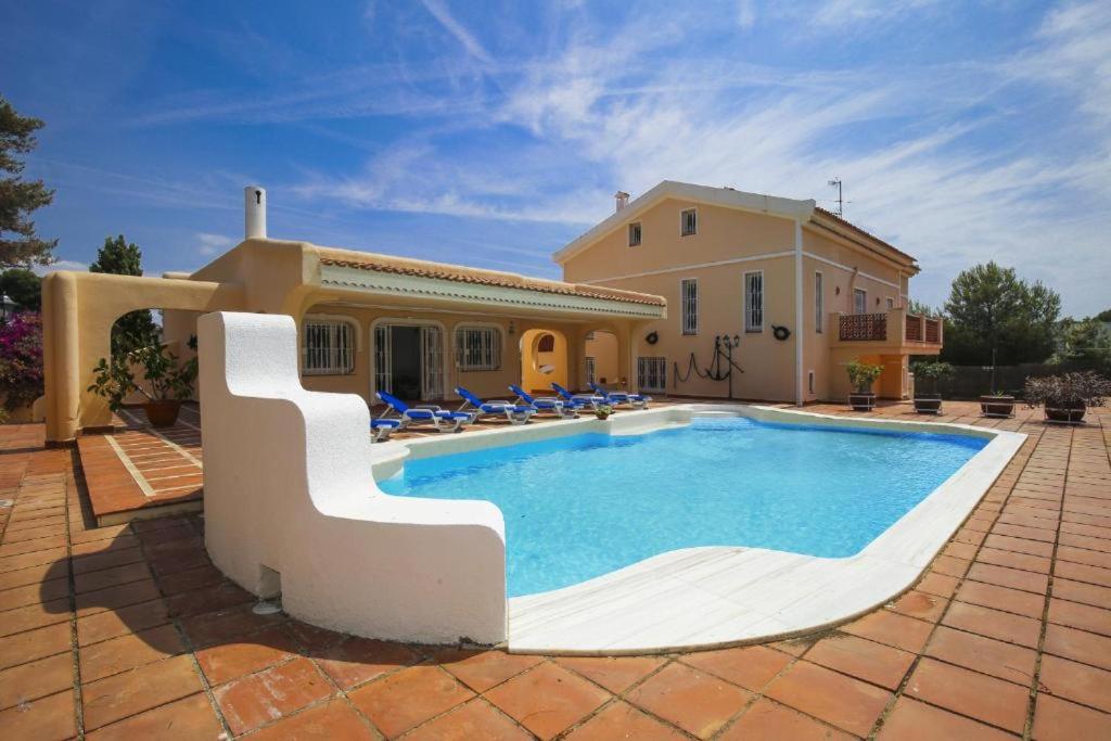 a villa with a swimming pool in front of a house at Spacious Private Villa with Pool in Salou in Salou