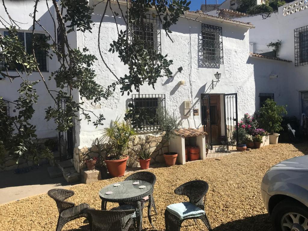 a table and chairs in front of a white building at Casa Tomas in Albox