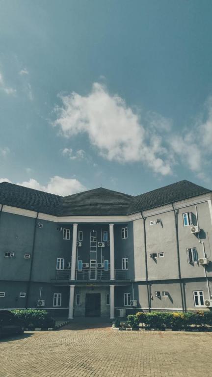 a large gray building with a sky in the background at Davic-lite hotel and suites in Okitipupa