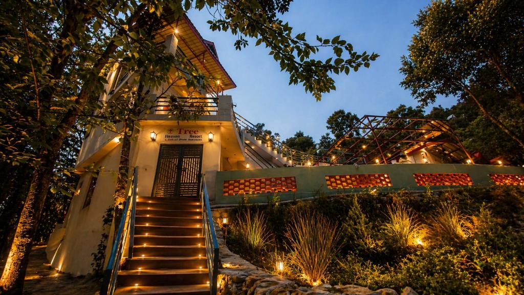 a staircase leading to a house with lights on it at Tree Heaven Resort-Kanatal in Kanatal
