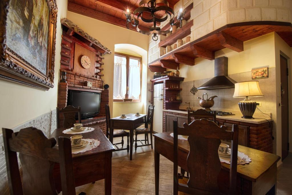 een woonkamer met een tafel en stoelen en een televisie bij B&B Trani Palace in Trani