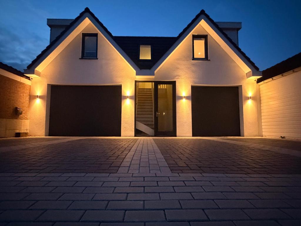 a house with two garage doors at night at Breeze Inn B&B in Oegstgeest