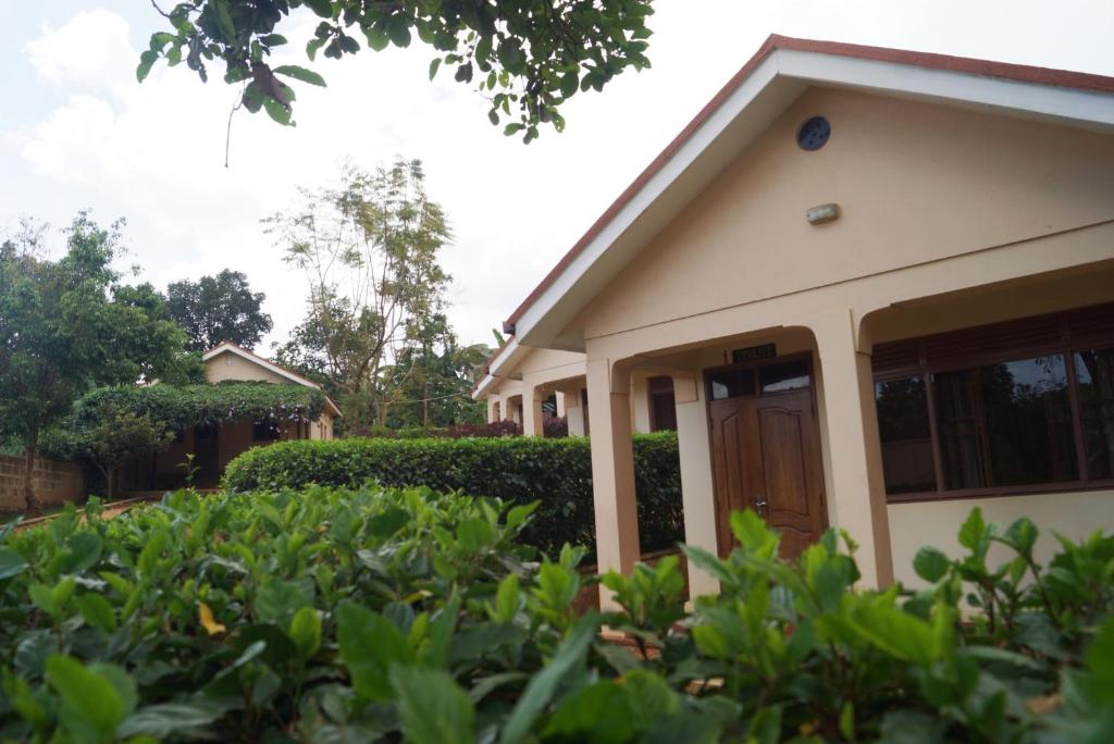 a house with a garden in front of it at JMR Cottages in Kampala