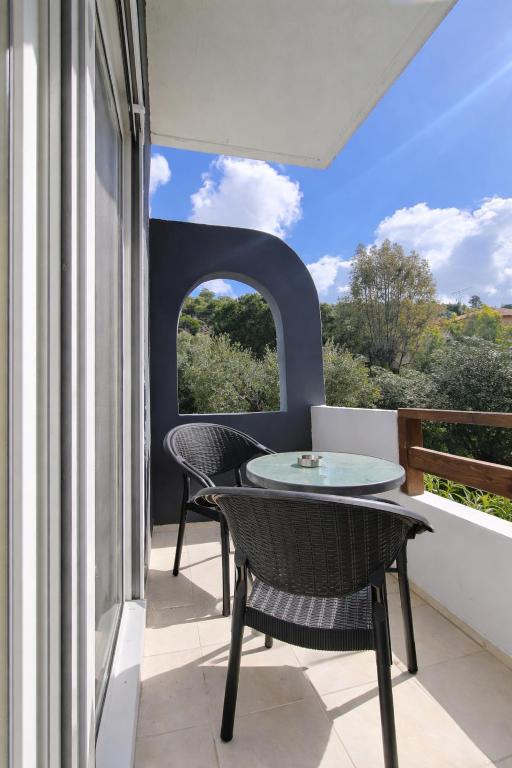 a patio with a table and chairs on a balcony at Paradise studios in Nikiti