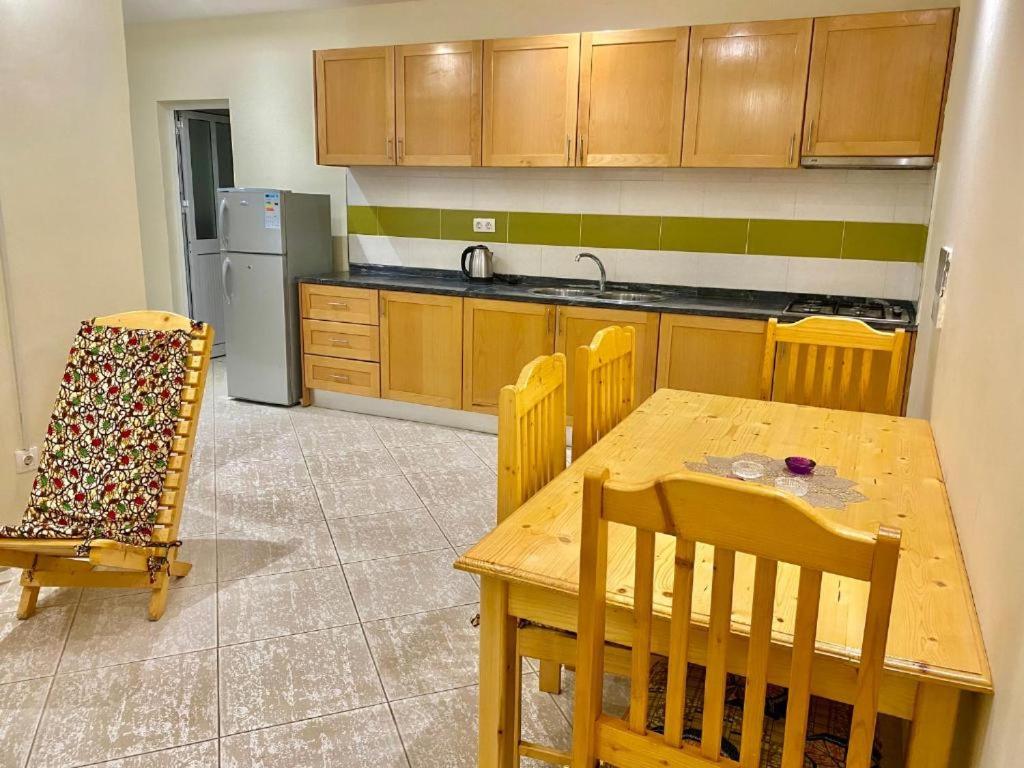 a kitchen with a table and chairs and a refrigerator at Monte Do Bem-Estar Tarrafal in Tarrafal
