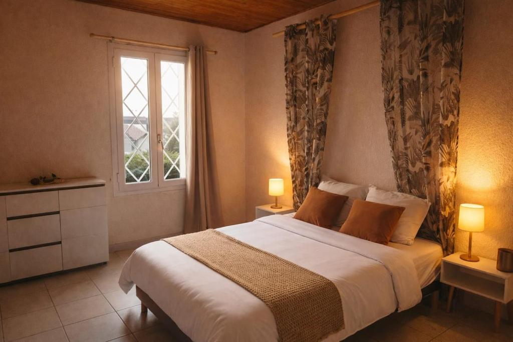 a bedroom with a large bed and a window at Charming accommodation for 2 people in ELNE in Elne