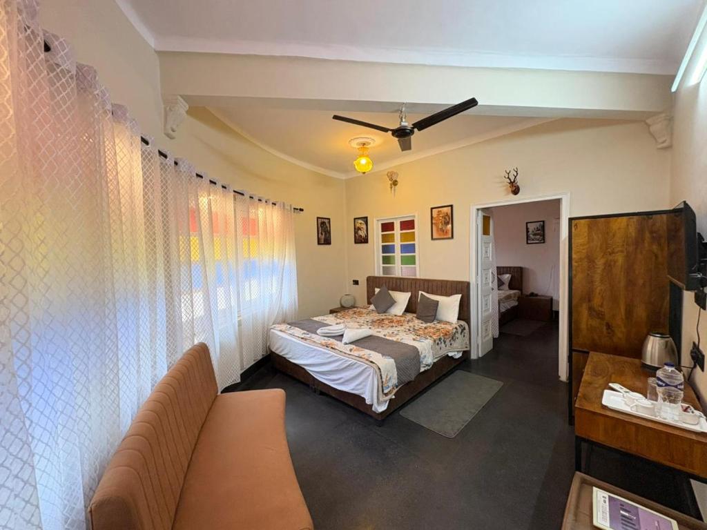 a bedroom with a bed and a couch in a room at L2 Darbar Kothi Heritage Living in Jodhpur