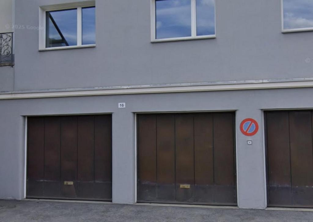 a row of four garage doors on a building at Apartment in Sankt Moritz in St. Moritz