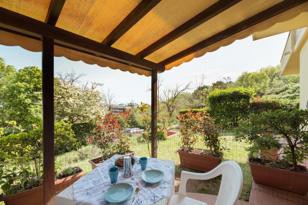 a table and chairs on the porch of a house at Residence azzurro VISTA MARE-A in Gabicce Mare