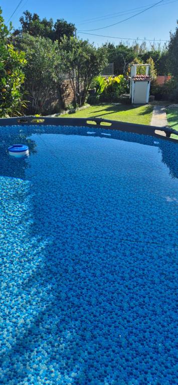 a large swimming pool filled with blue water at Casa Vitorino in Leiria