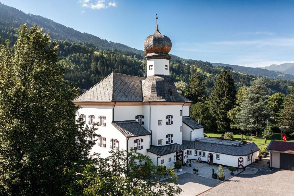 a large white building with a dome on top of it at Schloss & Boutique Hotel Mitterhart in Schwaz