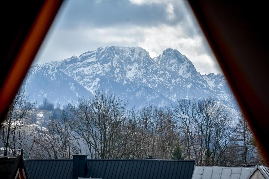 a large snow covered mountain in the distance at Pod Wyciągiem Harenda in Zakopane