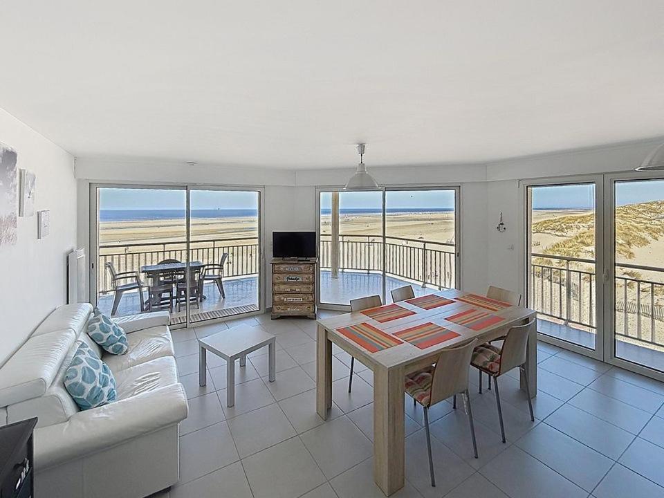 a living room with a couch and a table at Les Sables 4 in Fort-Mahon-Plage