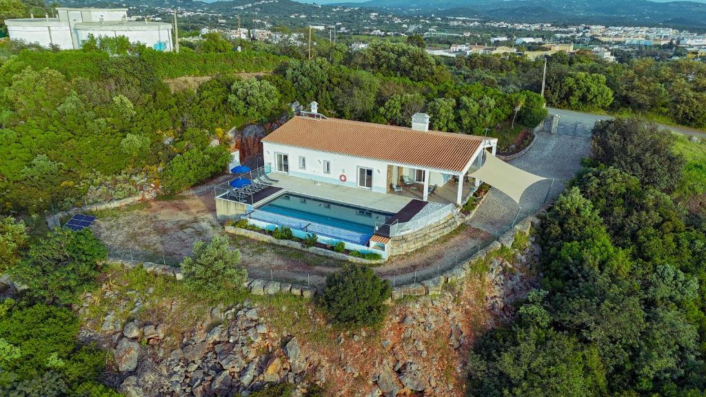 an overhead view of a house with a swimming pool at Villa Belchior by Algarve Holidays in Faro
