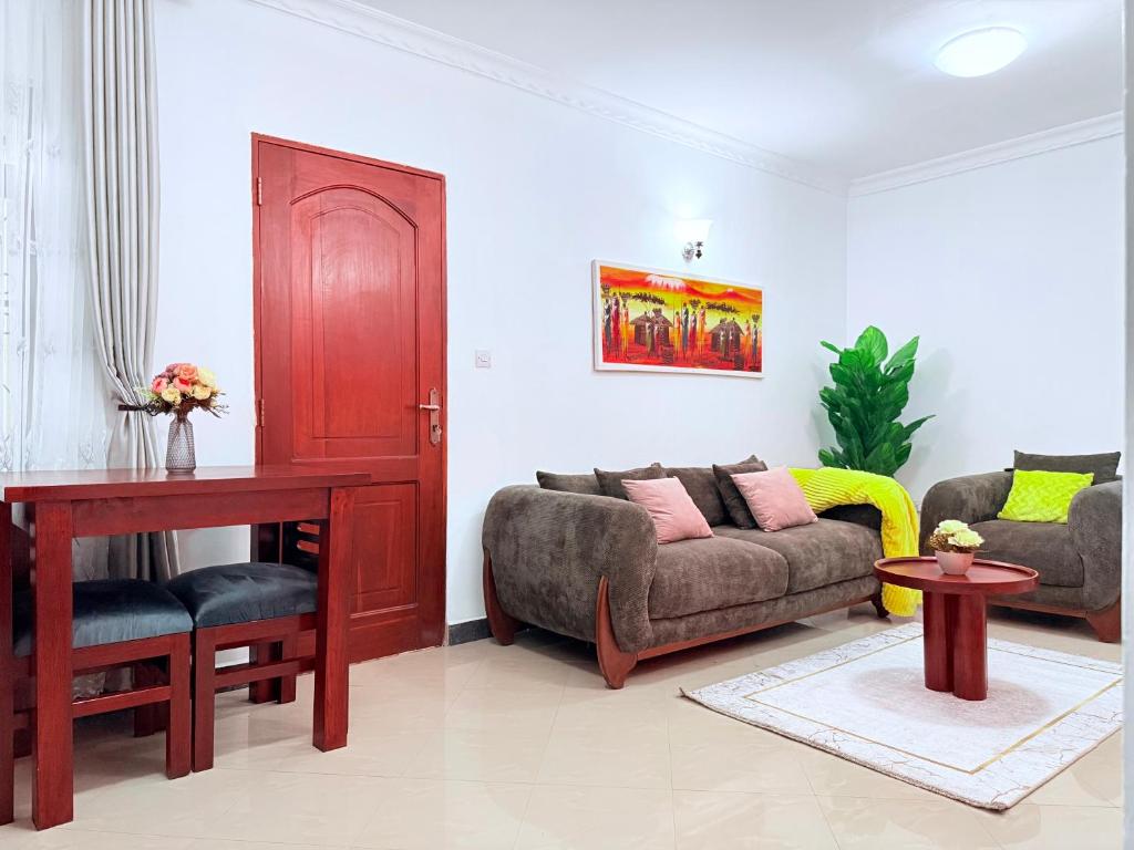 a living room with a couch and a table at Lumora Homes in Arusha