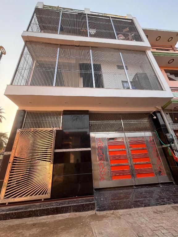 a tall building with orange and red garage doors at Suryavanshi Guest House in Ayodhya