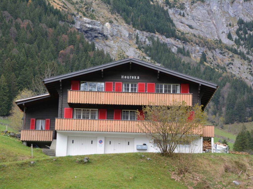 a large building with red doors on a mountain at Apartment Chalet Heureka-Horbis by Interhome in Engelberg