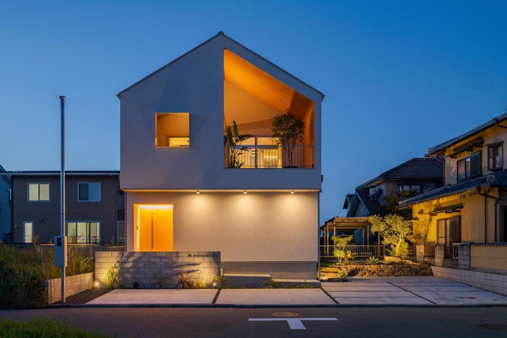 a house with lights on the side of it at NAGASHIMA clas in Kuwana