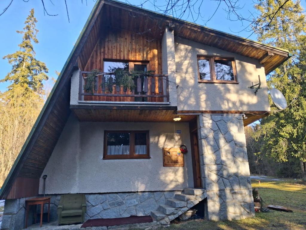 a house with a balcony on the side of it at Chata Anna Tatranská Štrba in Štrba