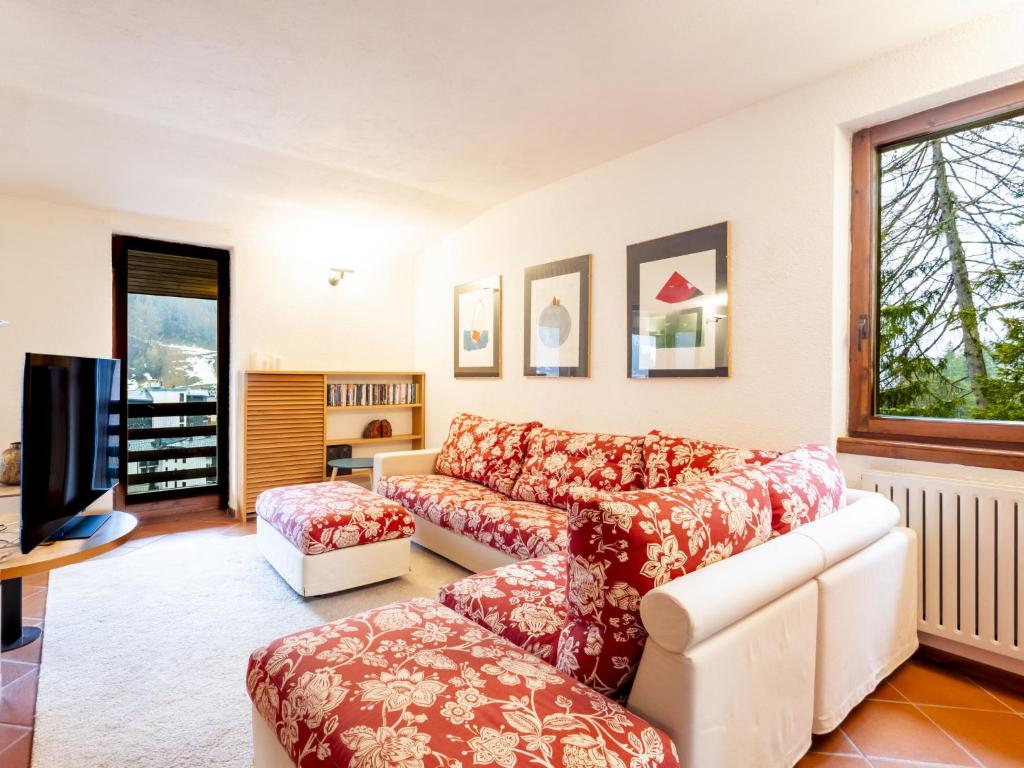 a living room with a couch and a tv at Apartment La Marmotta by Interhome in Madesimo