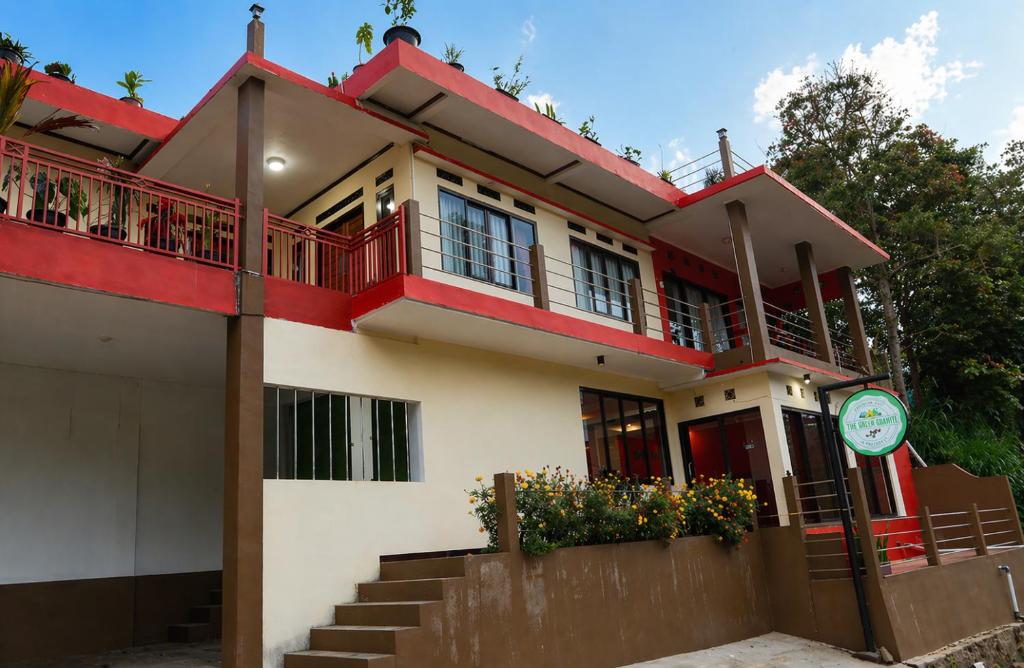 a house with a red and white at The Green County Homestay in Panglipurgalin