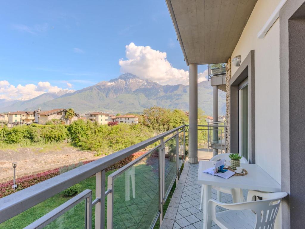 a balcony with a table and chairs and a mountain at Apartment Sole e Fiori by Interhome in Domaso
