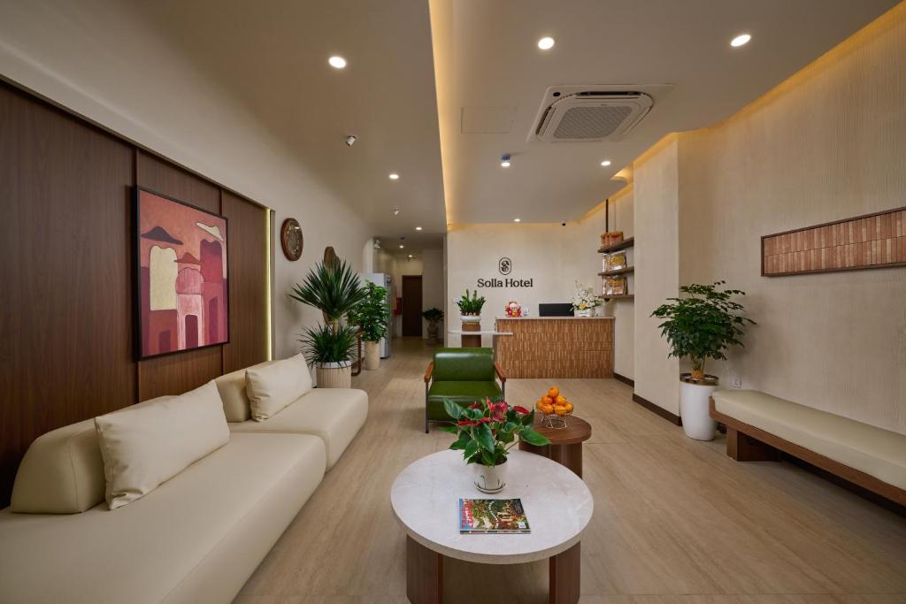 a living room with a couch and a table at Solla Hotel in Ninh Binh