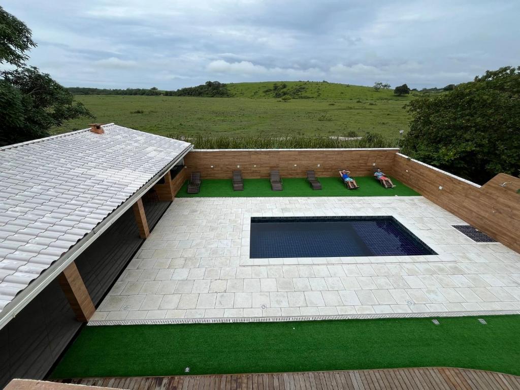 an overhead view of a patio with a pool and grass at Sonho Meu in Saquarema