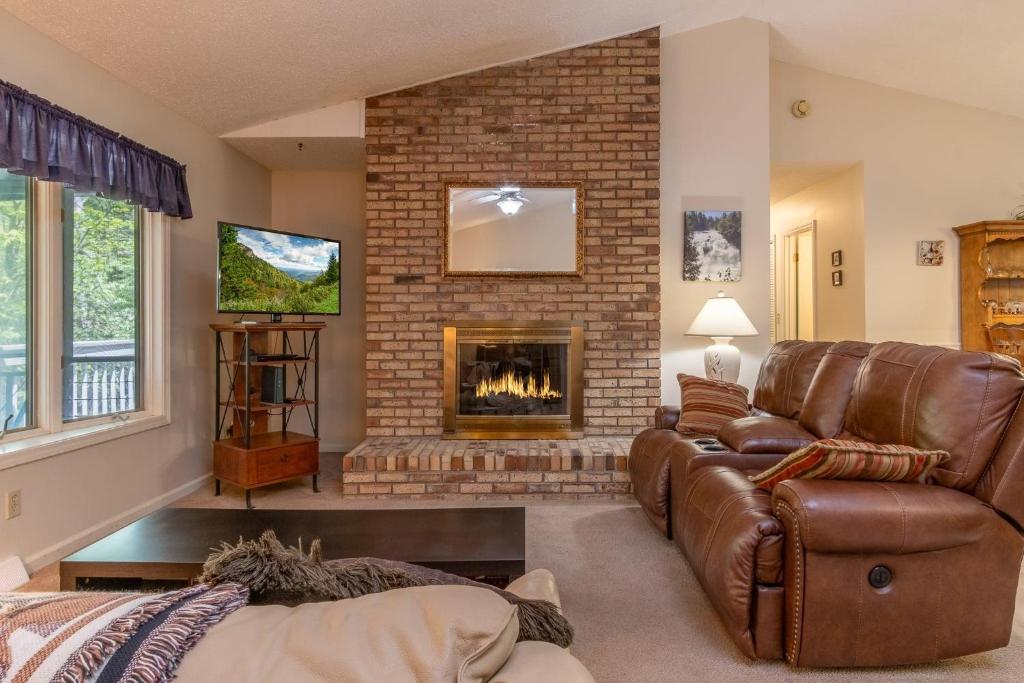 a living room with a couch and a fireplace at Home Away From Home · Home-Away-From-Home in Rosman