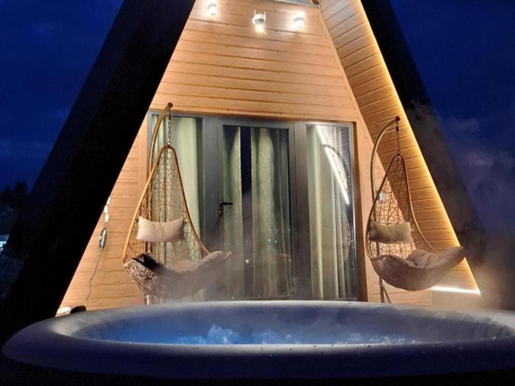 a bathroom with two swings and a tub at Hot Tub Paradise - Squirrel's House in Žabljak