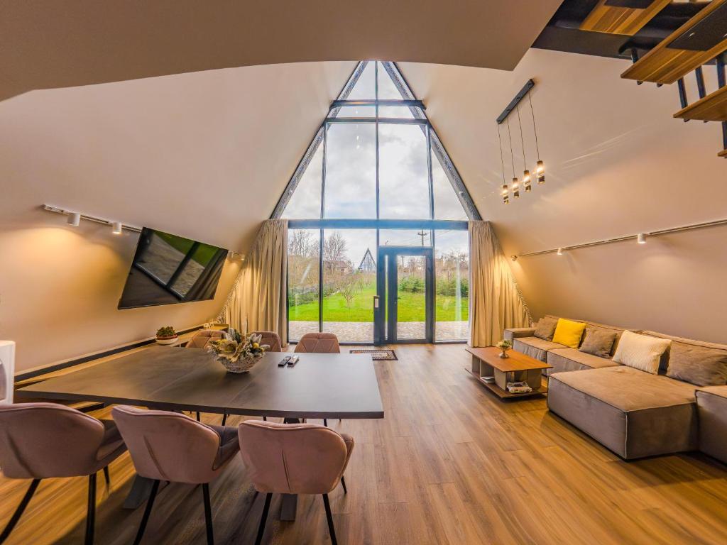 a living room with a table and a large window at Lotus 2 in Goruna