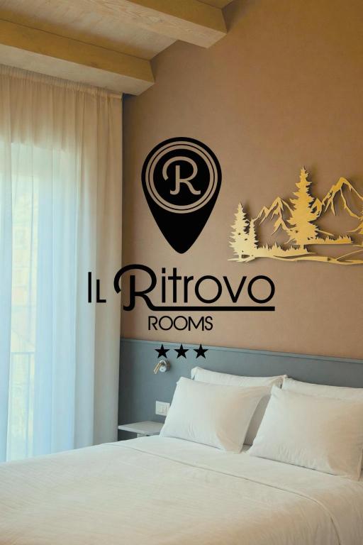 a bedroom with a bed with a sign on the wall at Il Ritrovo Rooms in Petralia Sottana