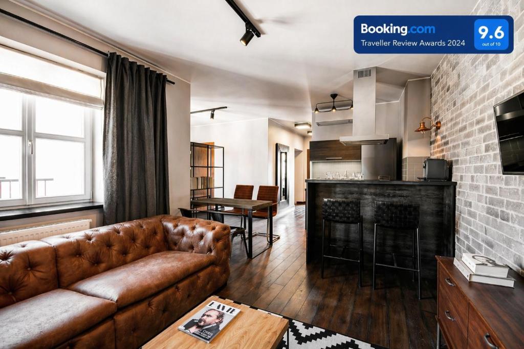 a living room with a couch and a table at Too-Good Premium Apartments in Krakow