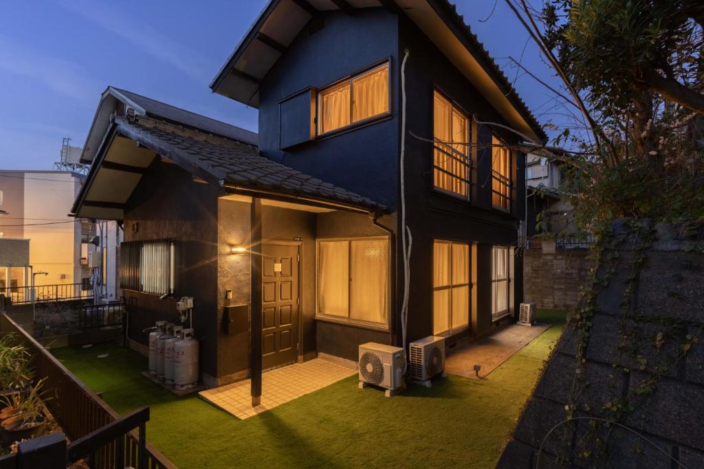 a blue house with a lawn in front of it at Tsuga1976 in Chiba