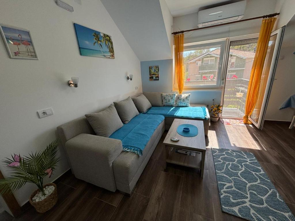 a living room with a couch and a table at Vila Mir Banja Vrujci in Gunjica