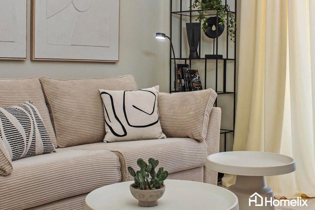 a living room with a couch and a table at Zoi Suite - fully renovated luxury apartment in Chalkida