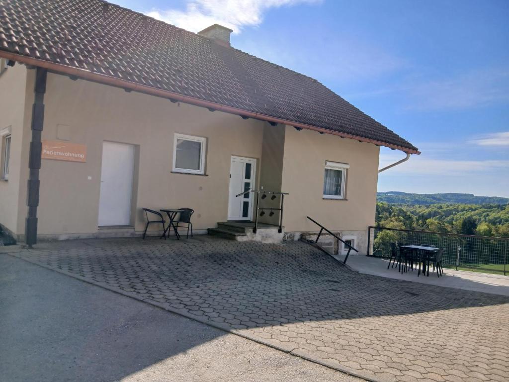 a building with a patio and a table and chairs at Urlaub am Weinhof Ramminger in Gleisdorf