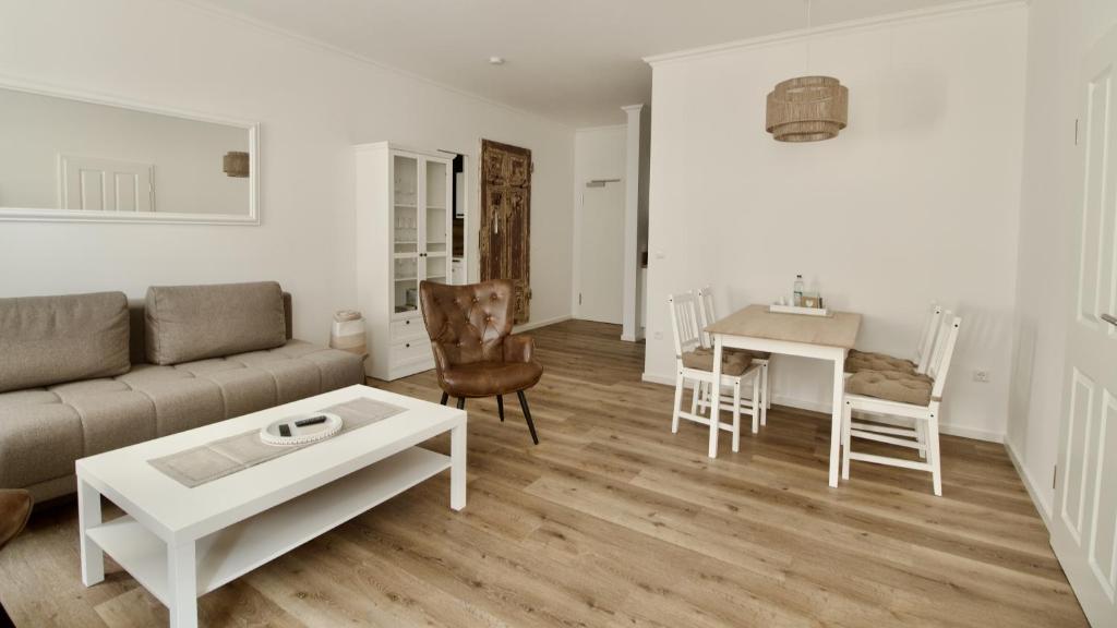a living room with a couch and a table at Ferienwohnungen EULE in Lutherstadt Wittenberg