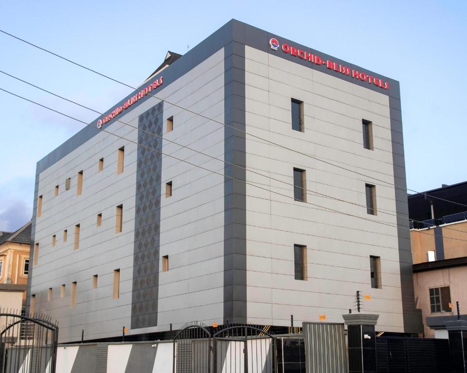 a white building with a sign on it at Orchid - Bliss Hotels in Lagos