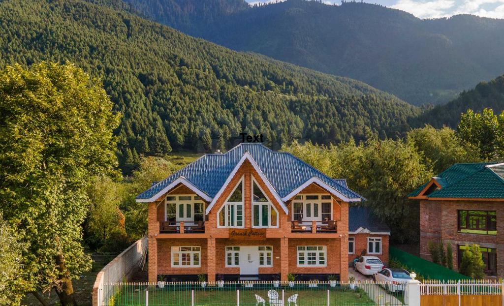 a large house in the middle of a mountain at Gaash Cottages in Buna Palang