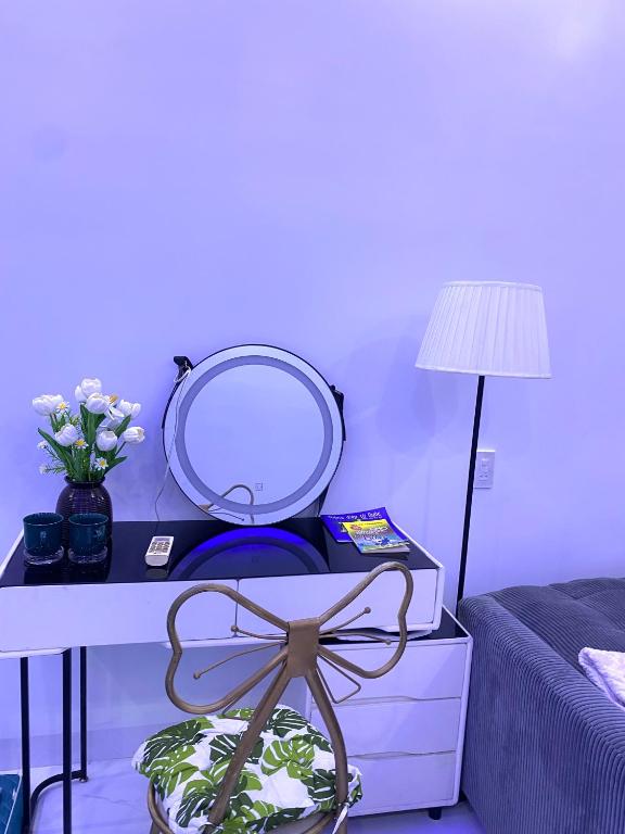 a bedroom with a dressing table with a mirror and a bed at Homestay giữa trung tâm Hải Phòng in An Dương