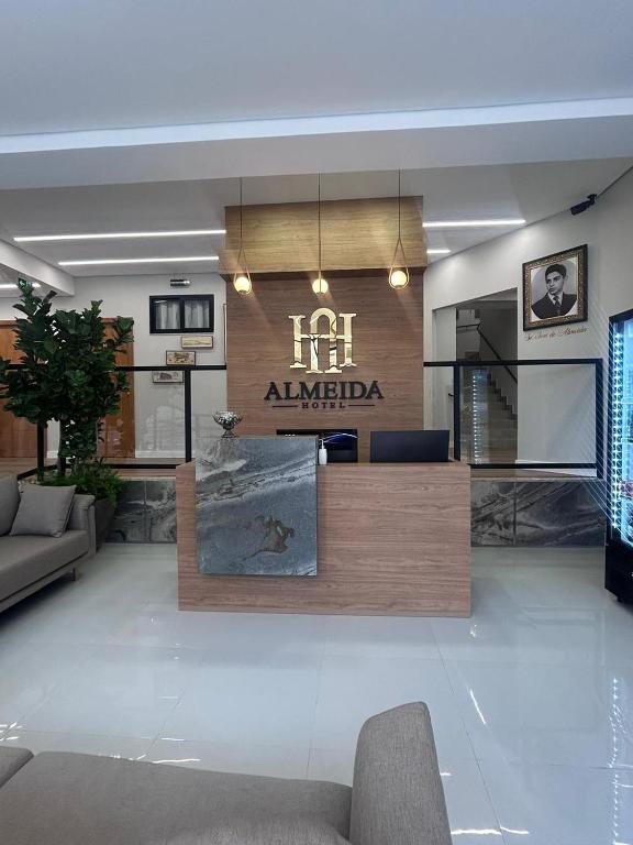 a living room with a couch and a lobby at Hotel Almeida in Montes Claros