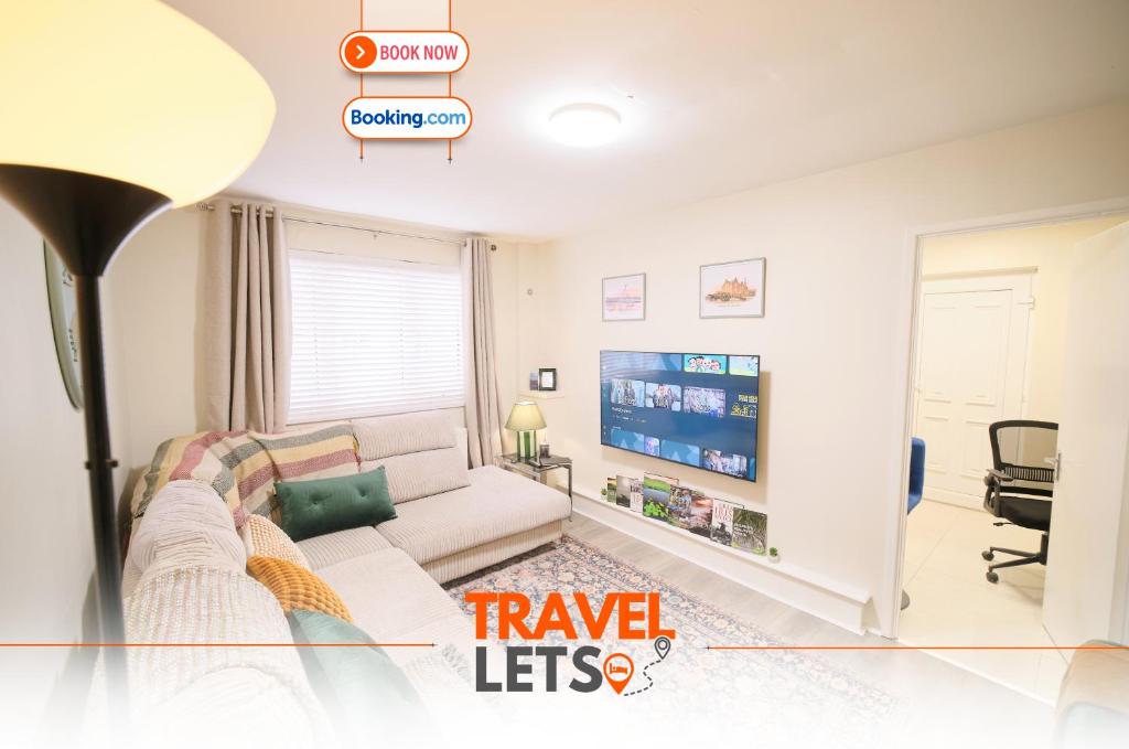 a living room with a couch and a tv at 1 Bedroom Apartment By Travel Lets Holiday Homes Derry Beside The City Walls in Derry Londonderry