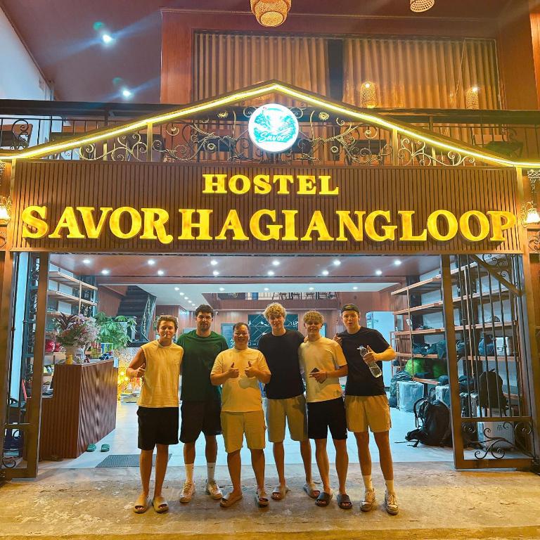 a group of men standing in front of a gym at Savor Hostel-Motorbike Rental-Tour in Làng Lap